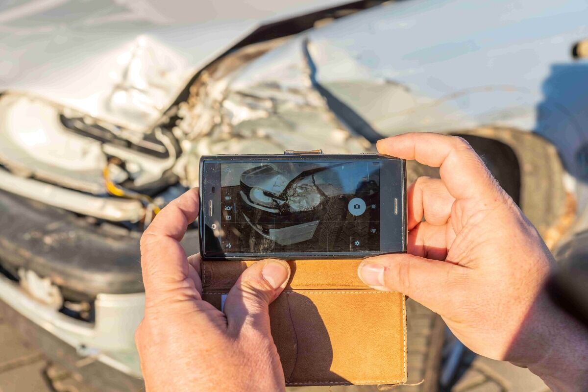 person documenting car accident