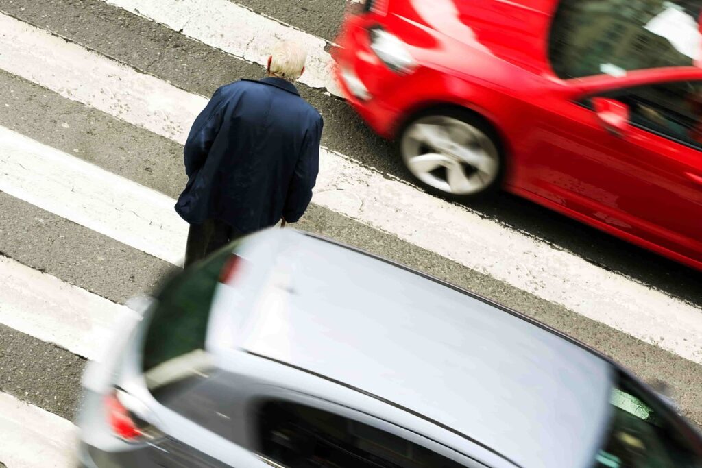 best injury lawyer in denver, older man crossing road near cars